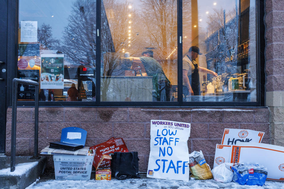 FILE - Starbucks employees who do not participate in a strike continue to work while a strike continues outside a store on Friday, Dec. 16, 2022 in St. Paul, Minn. One year after a Starbucks in Buffalo, New York, became the first to unionize in decades - touching off a wave of labor actions at other big companies like Amazon and Chipotle - the rush to organize Starbucks stores has slowed. (Kerem Yücel /Minnesota Public Radio via AP, File)