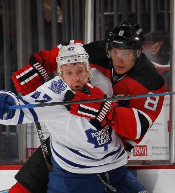 NEWARK, NJ - FEBRUARY 06:  Dainius Zubrus #8 of the New Jersey Devils and Leo Komarov #47 of the Toronto Maple Leafs tangle on the boards during the second period at the Prudential Center on February 6, 2015 in Newark, New Jersey. The Devils defeated the Maple Leafs 4-1. (Photo by Bruce Bennett/Getty Images)