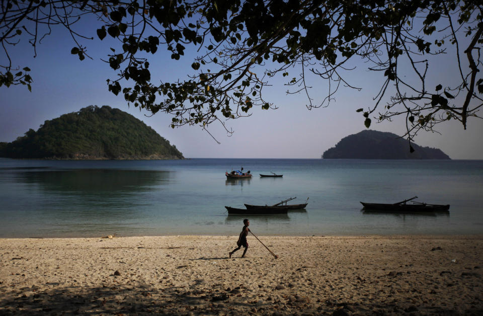 In this Sunday, Feb. 9, 2014 photo, a Moken boy, nomads of the sea, plays with a bamboo pole with a wooden wheel attached, on Island 115 in Mergui Archipelago, Myanmar. The boy is a group of a Moken group of several families spending 10 days hunting for squid and whatever else they can collect before returning to their village on another island toward Myanmar’s southwestern coast with a lacework of 800 islands, what is known as the Lost World. Isolated for decades by the country’s former military regime and piracy, the Mergui archipelago is thought by scientists to harbor some of the world’s most important marine biodiversity and looms as a lodestone for those eager to experience one of Asia’s last tourism frontiers before, as many fear, it succumbs to the ravages that have befallen many of the continent’s once pristine seascapes. (AP Photo/Altaf Qadri)