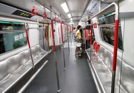 Passenger exit a stalled train during a disruption of Mass Transit Railway (MTR) services by protesters at Fortress Hill station in Hong Kong