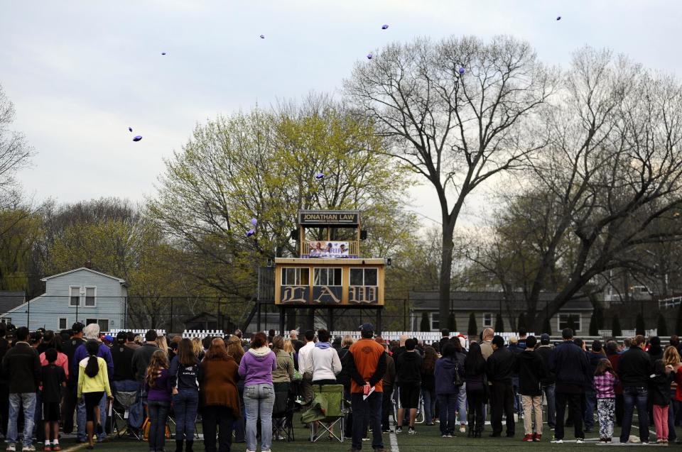 People release balloons as they attend during a vigil for Maren Sanchez on the football field at Jonathan Law High School, Monday, April 28, 2014, in Milford, Conn. Sanchez was fatally stabbed inside the school on Friday hours before her junior prom. (AP Photo/Jessica Hill)