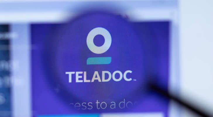 The Teladoc logo through a magnifying glass. Healthcare Tech Stocks