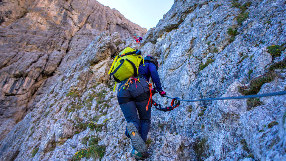 Woman climbing in a Black Diamond Speed 30 backpack