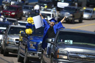 FILE - In this May 16, 2020, file photo Jaime Susano, a graduating senior from Buckeye Union High School, shouts in celebration during the Parade of Graduates, a drive-thru graduation ceremony, on the race track at Phoenix Raceway in Avondale, Ariz. High schools across the country have added pomp to their circumstances to make graduations special amid the coronavirus pandemic. (AP Photo/Ross D. Franklin, File)