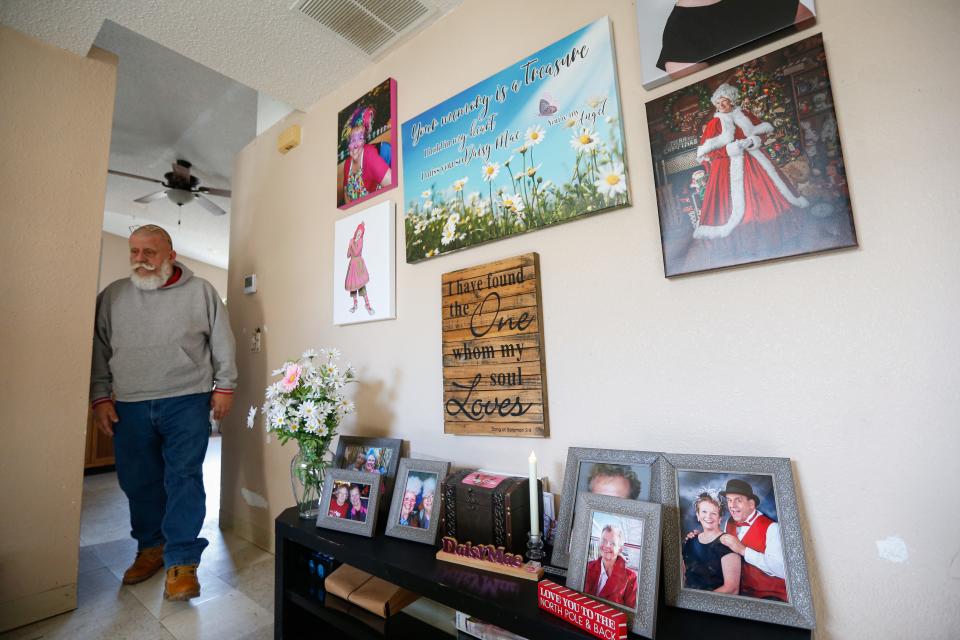 Spangle the Clown walks near the memorial he made for his late wife Daisy Mae in his home in Fair Grove on Wednesday, Dec. 28, 2022. Spangle and Daisy performed as clowns and Santa Claus and Mrs. Claus together. Daisy died in a car accident in March 2022.