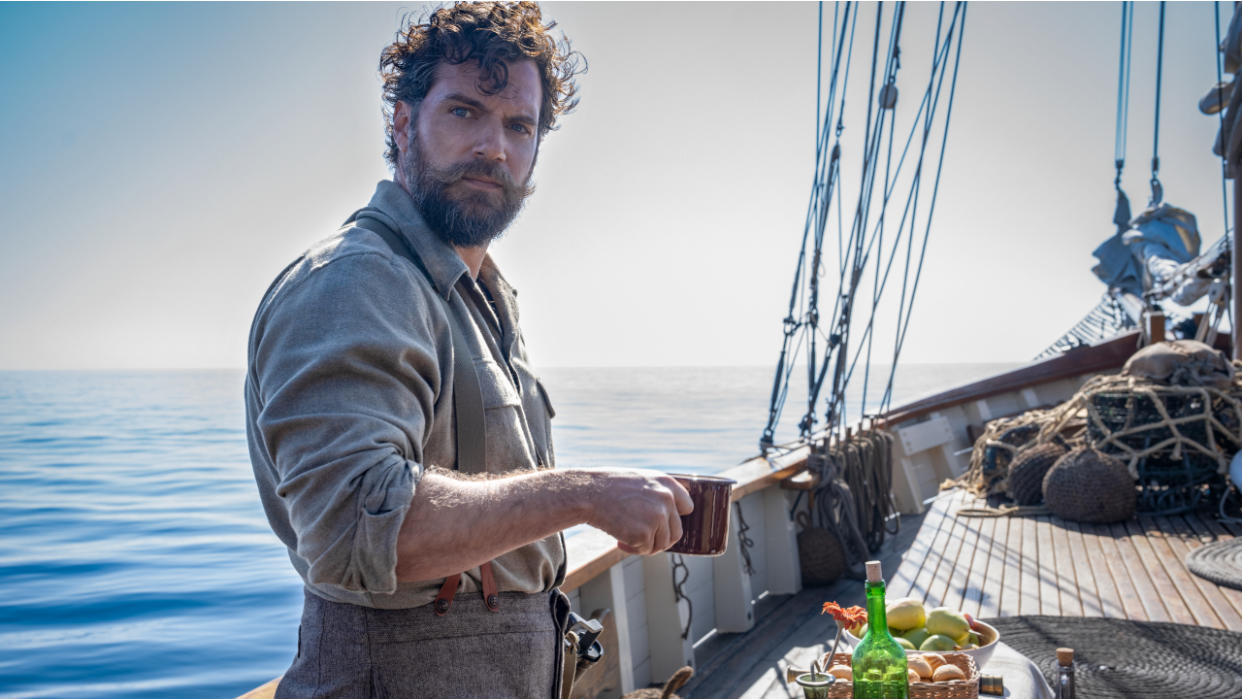  Henry Cavill drinking coffee on a boat deck in The Ministry of Ungentlemanly Warfare. 