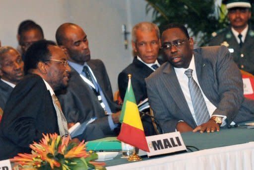 Dioncounda Traore (left), the interim president of Mali speaks with Senegalese President Macky Sall during an emergency ECOWAS summit held to discuss violence and unrest in Mali and Guinea Bissau, on April 26, 2012, in Abidjan