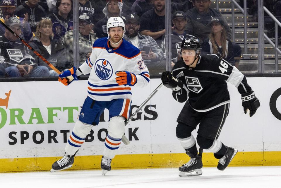 Kings forward Blake Lizotte, right, skates in front of Edmonton Oilers defenseman Brett Kulak during Game 4 on Sunday.