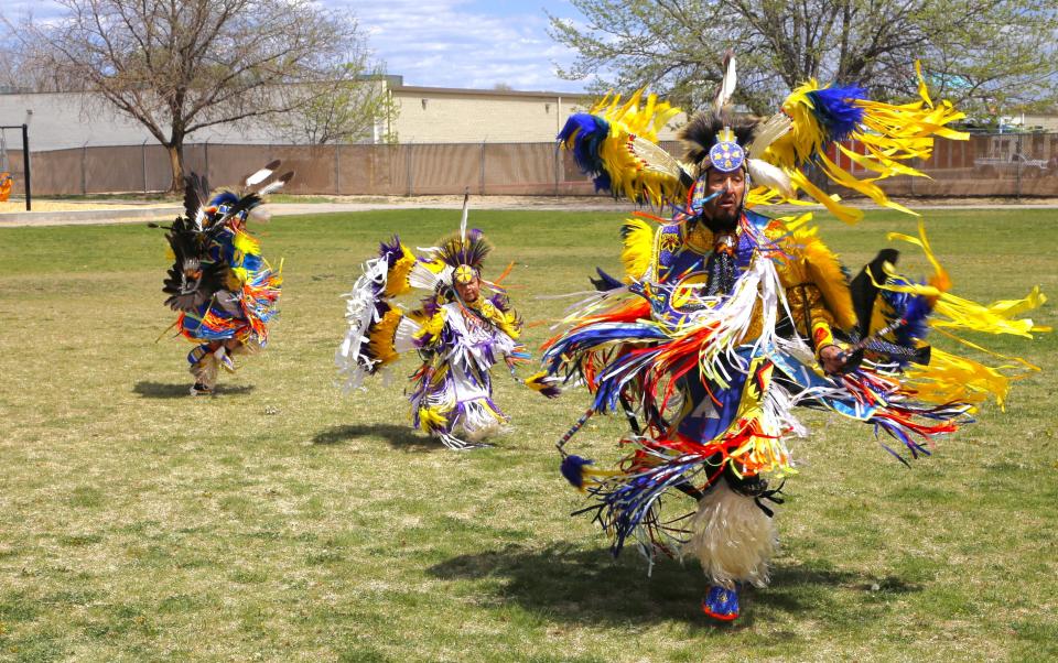 Mason, left, Aspen and Sheldon Johnson perform during a Monday, April 22 community garden party at Animas Elementary School in Farmington.