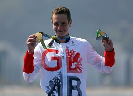 2016 Rio Olympics - Triathlon - Men's Victory Ceremony - Fort Copacabana - Rio de Janeiro, Brazil - 18/08/2016. Alistair Brownlee (GBR) of Britain poses with his medal. REUTERS/Damir Sagolj