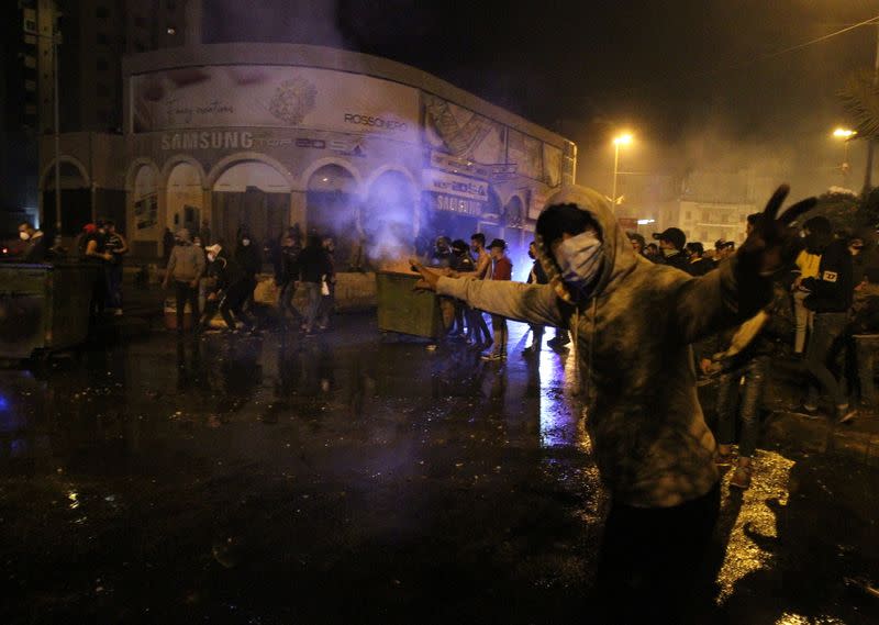 A demonstrator gestures during a protest against the lockdown and worsening economic conditions, amid the spread of the coronavirus disease (COVID-19), in Tripoli