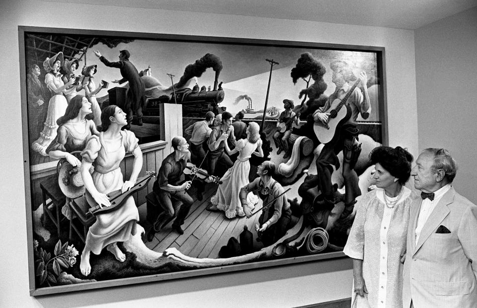 Art collectors Olga and Joseph Hirshhorn examine Thomas Hart Benton's painting "The Sources of Country Music" at the Country Music Hall of Fame and Museum in Nashville on June 12, 1981.