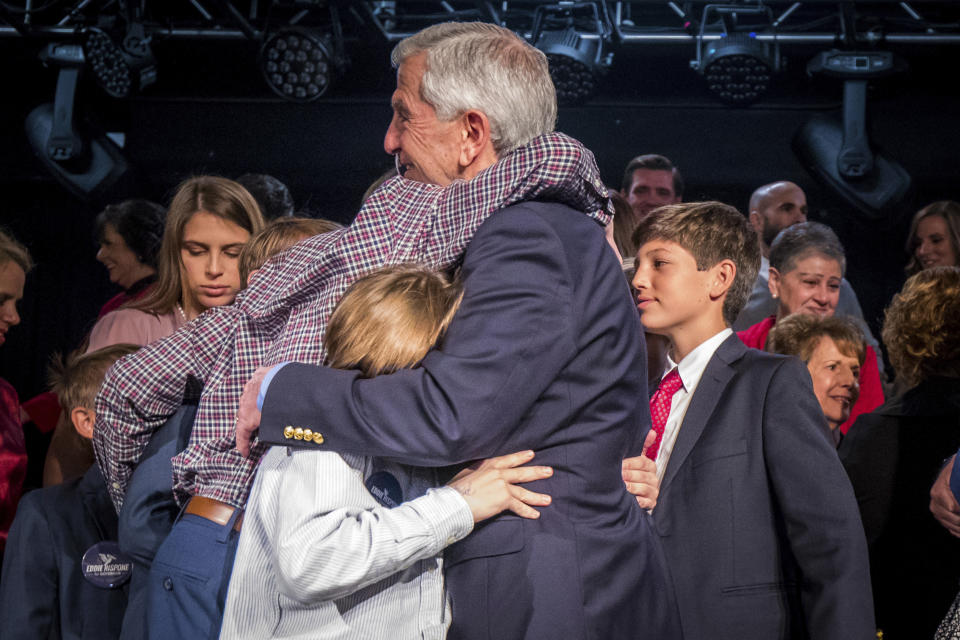 Louisiana Republican gubernatorial candidate Eddie Rispone hugs family at his election night watch party at L'Auberge Casino and Hotel in Baton Rouge, La., Saturday, Nov. 16, 2019. (AP Photo/Sophia Germer)