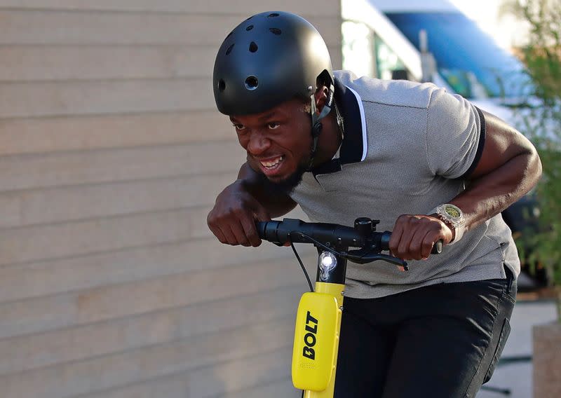 FILE PHOTO: Former sprinter Usain Bolt rides an electric scooter during the international launching of Bolt Electric Scooters by Bolt Mobility in Paris