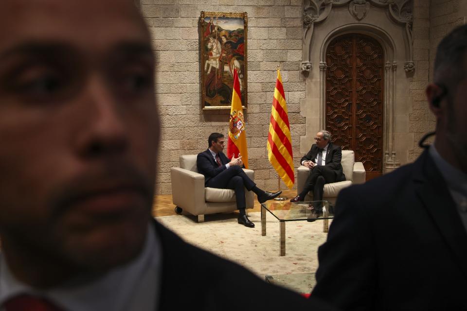 Spanish Prime Minister Pedro Sanchez, center and left, talks with Catalan regional President Quim Torra, center and right, at the Palace of the Generalitat, the headquarter of the Government of Catalonia, in Barcelona, Thursday, Feb. 6, 2020. (AP Photo/Emilio Morenatti)