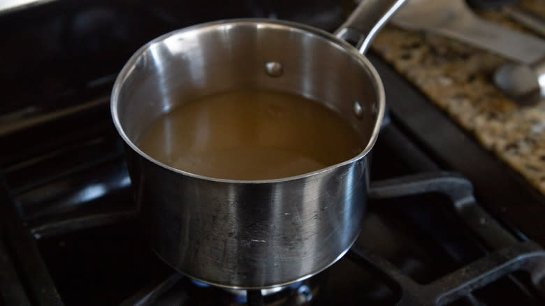 heating broth in saucepan