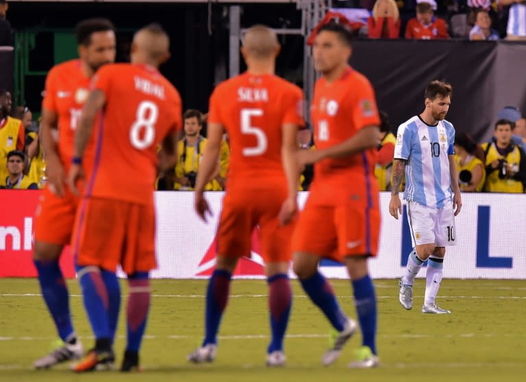 Argentina's Lionel Messi (R) reacts after missing his shot during the penalty shoot-out against Chile, during their Copa America Centenario final in East Rutherford, New Jersey, on June 26, 2016