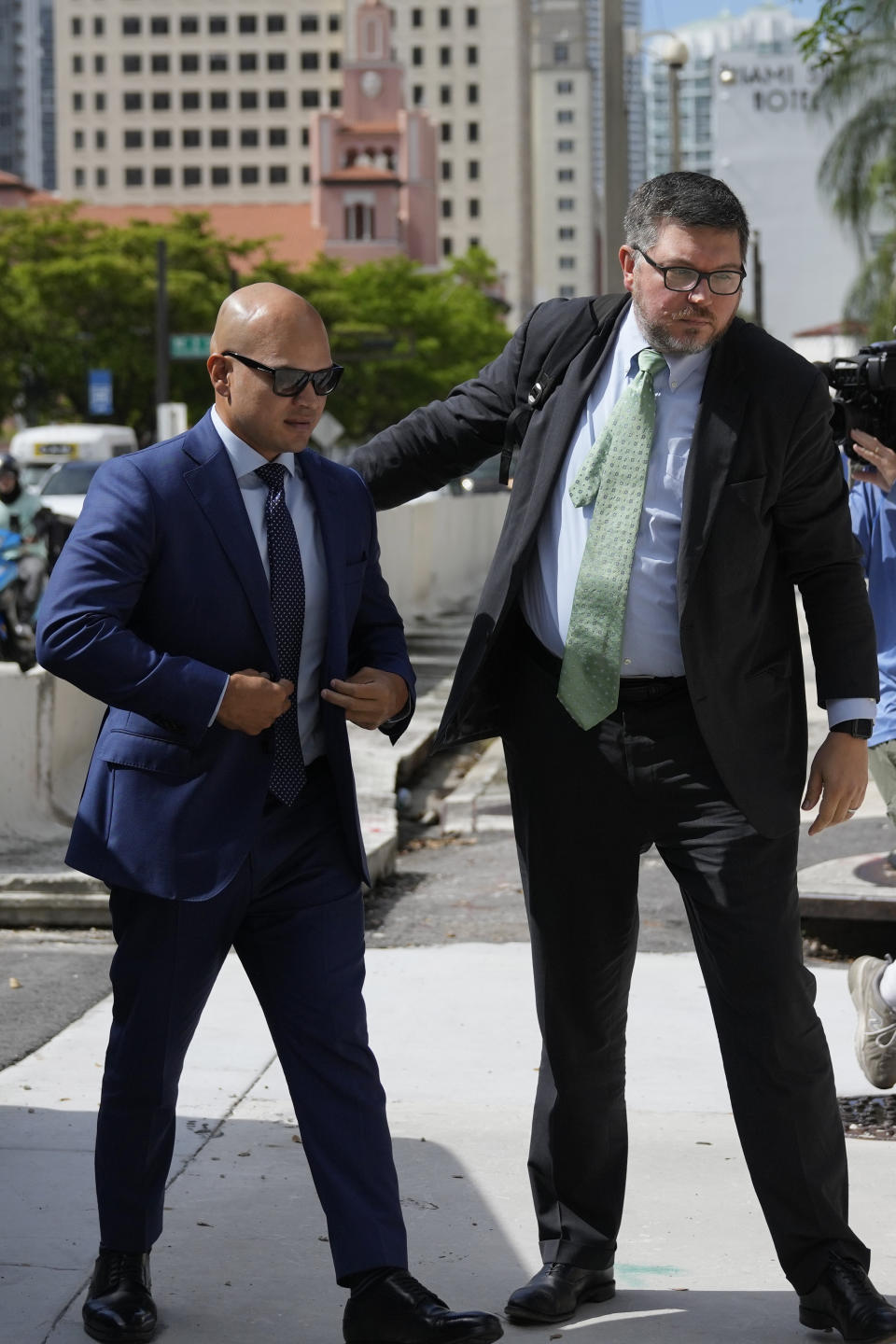 Walt Nauta, left, a valet to former President Donald Trump who is charged with helping the ex-president hide classified documents the Justice Department wanted back, arrives with defense attorney Stanley Woodward at the James Lawrence King Federal Justice Building for his arraignment, in Miami, Thursday, July 6, 2023. (AP Photo/Rebecca Blackwell)