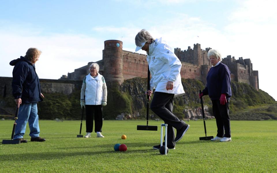 Members of the Bamburgh Croquet club play a game following the easing of Covid-19 restrictions - REUTERS/Lee Smith