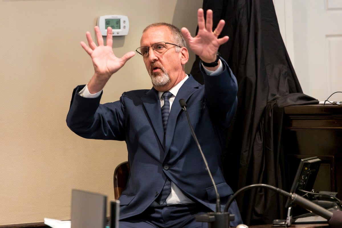 Tim Palmbach, a forensic scientist, demonstrates the affect of a shotgun blast (AP)