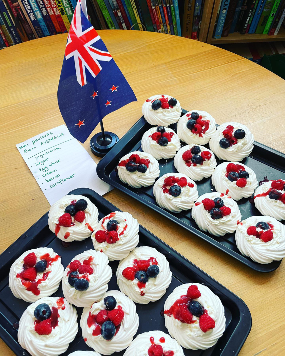 Carrie Bickmore's trays of pavlovas next to a New Zealand flag.
