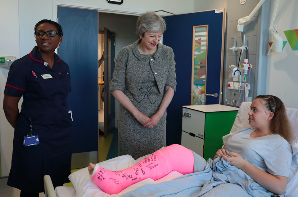 <em>Mrs May speaks to patient Jade Myers, 15, from London, who broke her leg falling off a wall, during her tour of the Royal Free Hospital (PA)</em>