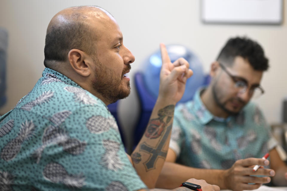 Andres Acosta Ardila, director of community relations at Pineapple Healthcare, speaks during a staff meeting at the medical clinic in Orlando, Fla., on May 28, 2024. (AP Photo/Phelan M. Ebenhack)