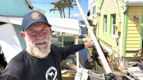 PHOTO: John Lynch points to his home which was damaged when Hurricane Ian struck the area, in Matlacha, Fla. (Miles Cohen/ABC News)