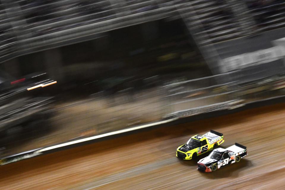 BRISTOL, TENNESSEE - APRIL 16: Matt Crafton, driver of the #88 Great Lakes Flooring/Menards Toyota, and Buddy Kofoid, driver of the #51 Mobil 1 Toyota, race during the NASCAR Camping World Truck Series Pinty\