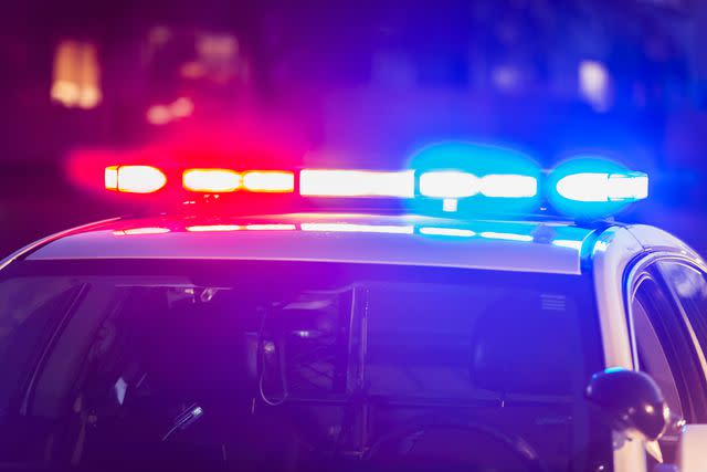 <p>Getty</p> Stock image of roof of a police patrol car at night, with the blue and red lights flashing.