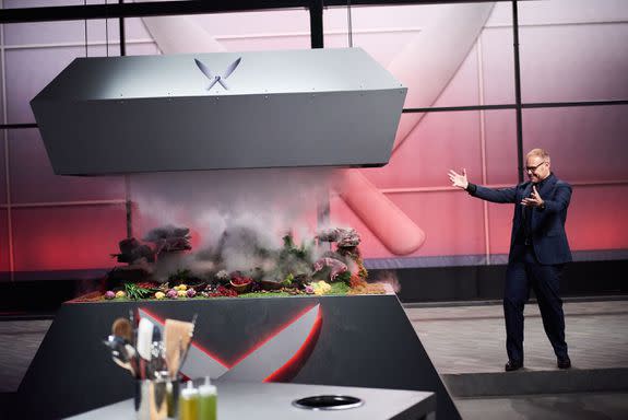 Host Alton Brown revealing the Chairman Challenge, as seen on Iron Chef Gauntlet, Season 1.