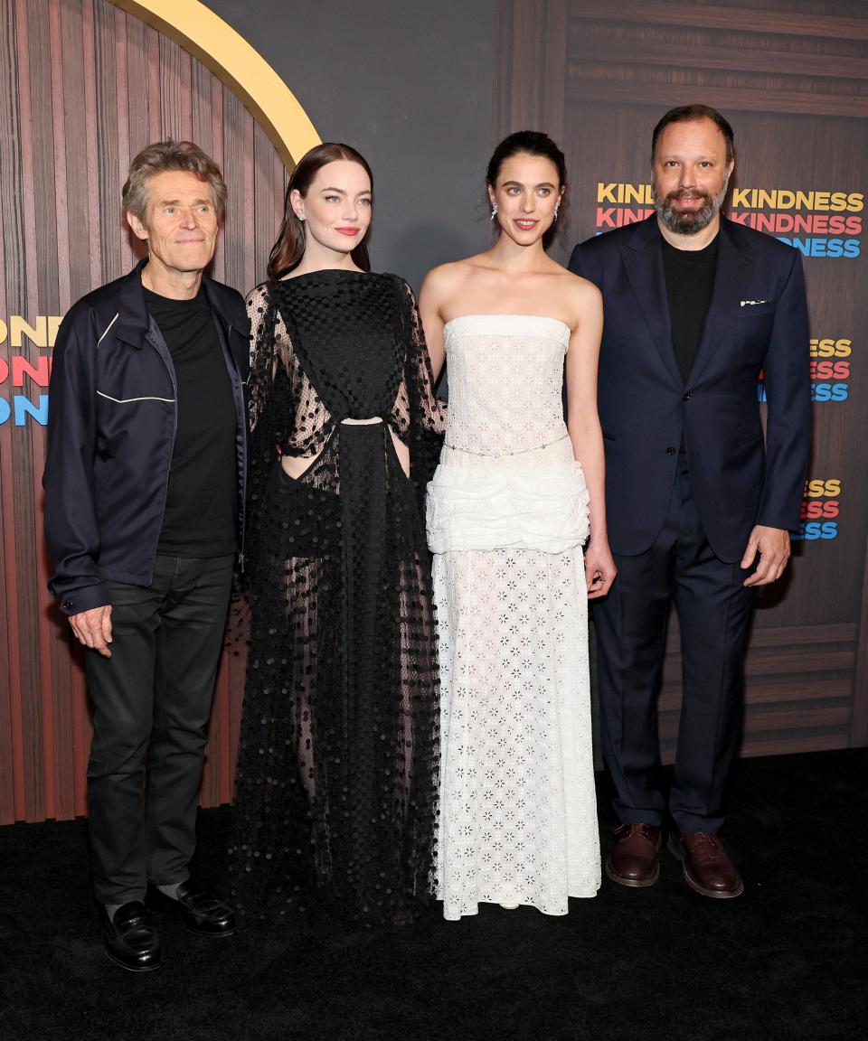 Willem Dafoe, Emma Stone, Margaret Qualley, and Yorgos Lanthimos pose for a group photo at the Kinds of Kindness premiere in New York City.