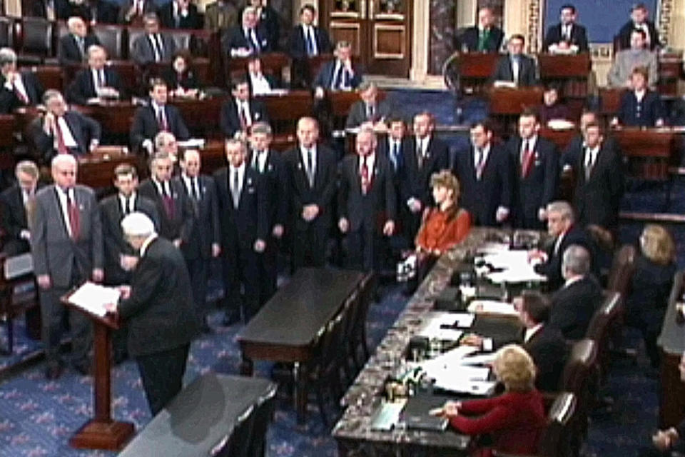 FILE - In this Jan. 7, 1999, image from video, House Judiciary Committee Chairman Rep. Henry Hyde, R-Ill., reads the articles of impeachment against President Bill Clinton to the Senate as the other House managers who will conduct the impeachment trial watch in Washington. As House Democrats quickly move forward with impeachment proceedings against President Donald Trump, much remains unknown about how a Senate trial would a proceed, including what the charges would be. (AP Photo/APTN)