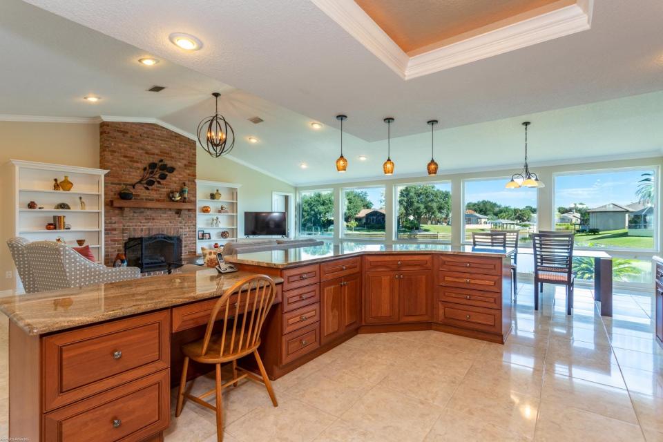 The eat-in kitchen is a chef’s dream, with solid cherry-wood cabinets, granite countertops, tile backsplash, an island and new KitchenAid appliances (except for the stove).