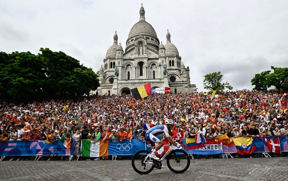 France's Valentin Madouas cycles past the Basilica of Sacre Coeur during the men's cycling road race during the Paris 2024 Olympic Games