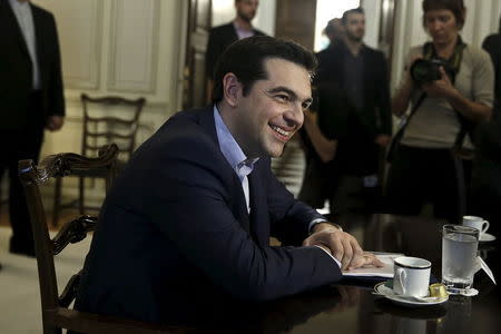 Greek Prime Minister Alexis Tsipras smiles during a meeting with Iranian Foreign Minister Mohammad Javad Zarif (not pictured) in Athens May 28, 2015. REUTERS/Alkis Konstantinidis