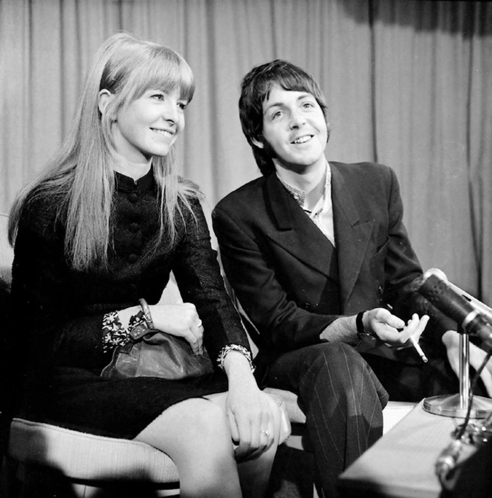 Close-up of Paul and Jane sitting together in front of a microphone