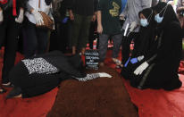 Aldha Refa, left, wife of steward Okky Bisma, one of victims of Sriwijaya Air passenger jet crash, cries during his funeral in Jakarta, Indonesia Thursday, Jan. 14, 2021. An aerial search for victims and wreckage of a crashed Indonesian plane expanded Thursday as divers continued combing the debris-littered seabed looking for the cockpit voice recorder from the lost Sriwijaya Air jet.(AP Photo)