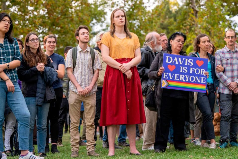 Members of the LGBTQ community and supporters stand in unity during a rally Tuesday at Davis’ Central Park after recent bomb threats against the city’s schools and library.