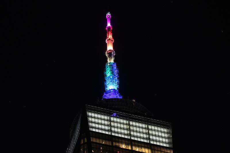 The spire of One World Trade Center is lit in rainbow colors in Manhattan