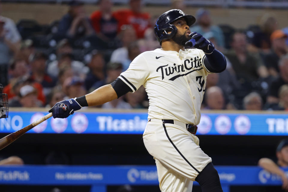 Minnesota Twins' Carlos Santana follows through on a two-run home run against the Colorado Rockies during the ninth inning of a baseball game Tuesday, June 11, 2024, in Minneapolis. (AP Photo/Bruce Kluckhohn)