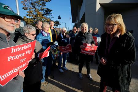 U.S. Senator Maggie Hassan (D-NH) (C) joins demonstrators holding an "Interfaith Prayer Vigil for Immigrant Justice" outside the federal building, where ethnic Chinese Christians who fled Indonesia after wide scale rioting decades ago and overstayed their visas in the U.S. must check-in with ICE, in Manchester, New Hampshire, U.S., October 13, 2017. REUTERS/Brian Snyder