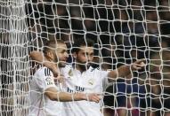 Real Madrid's Karim Benzema (L) celebrates his goal against Deportivo Coruna with teammate Alvaro Arbeloa during their Spanish first division soccer match at Santiago Bernabeu stadium in Madrid, February 14, 2015. REUTERS/Susana Vera