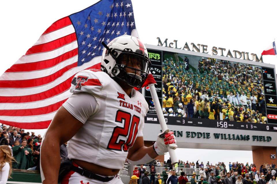 Texas Tech's Kosi Eldridge (20) runs on the field prior to the team’s NCAA football game against Baylor on Saturday, Nov. 27, 2021 at John Eddie Williams Field at McLane Stadium in Waco, Texas.