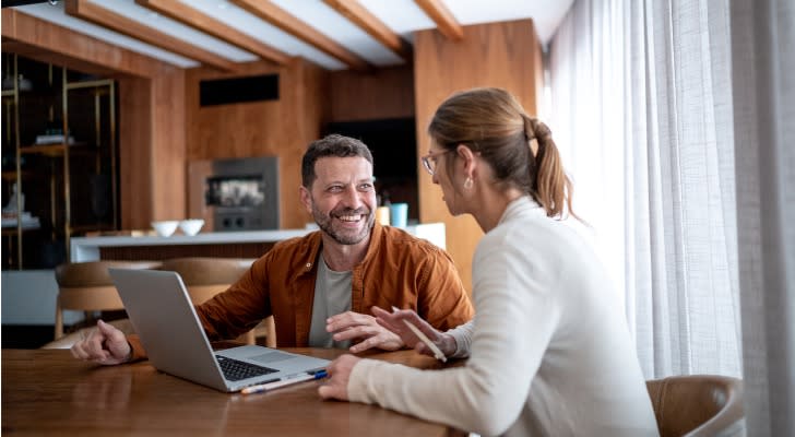 A married couple discusses their comprehensive financial plan. 