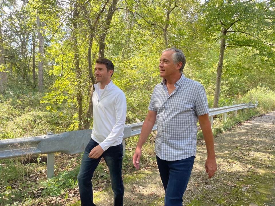 Jordan Dick, left, and his father, Mark, walk through a portion of the 270-acre property in Howell in 2021.