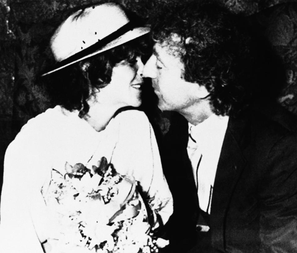 Comedian Gilda Radner, left, and Gene Wilder, kiss for photographers in this photograph following their private wedding ceremony, 1984, France.