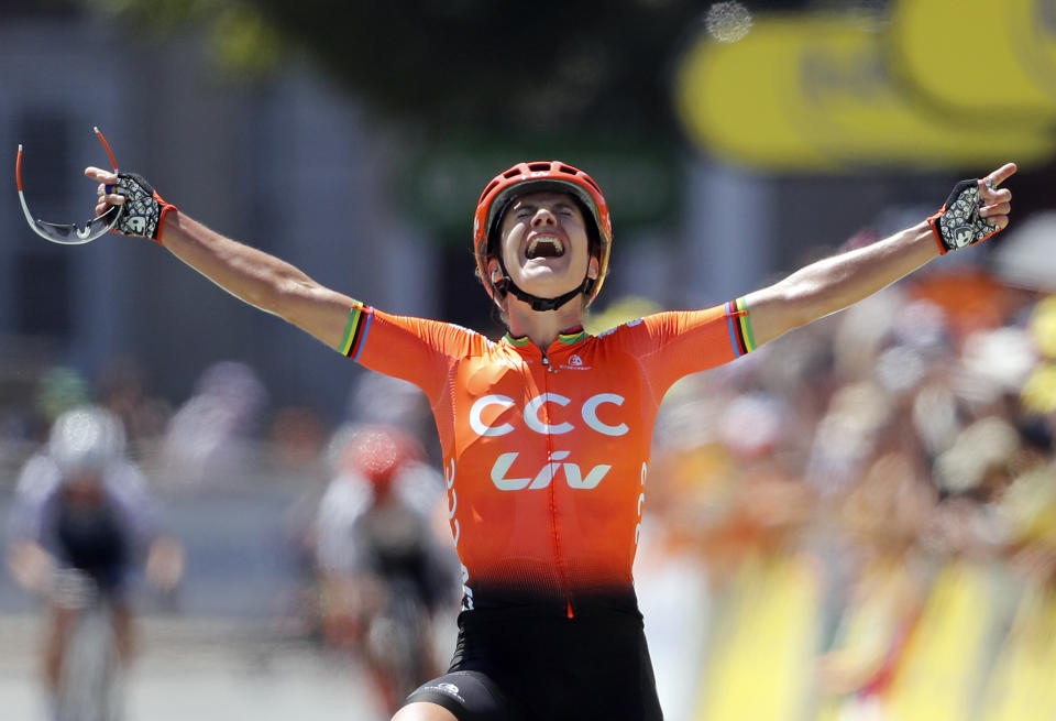 Marianne Vos, of the Netherlands celebrates as she crosses the finish line to win La Course by Le Tour de France, a women's cycling race, with start and finish in Pau, France, Friday, July 19, 2019. (AP Photo/Christophe Ena)