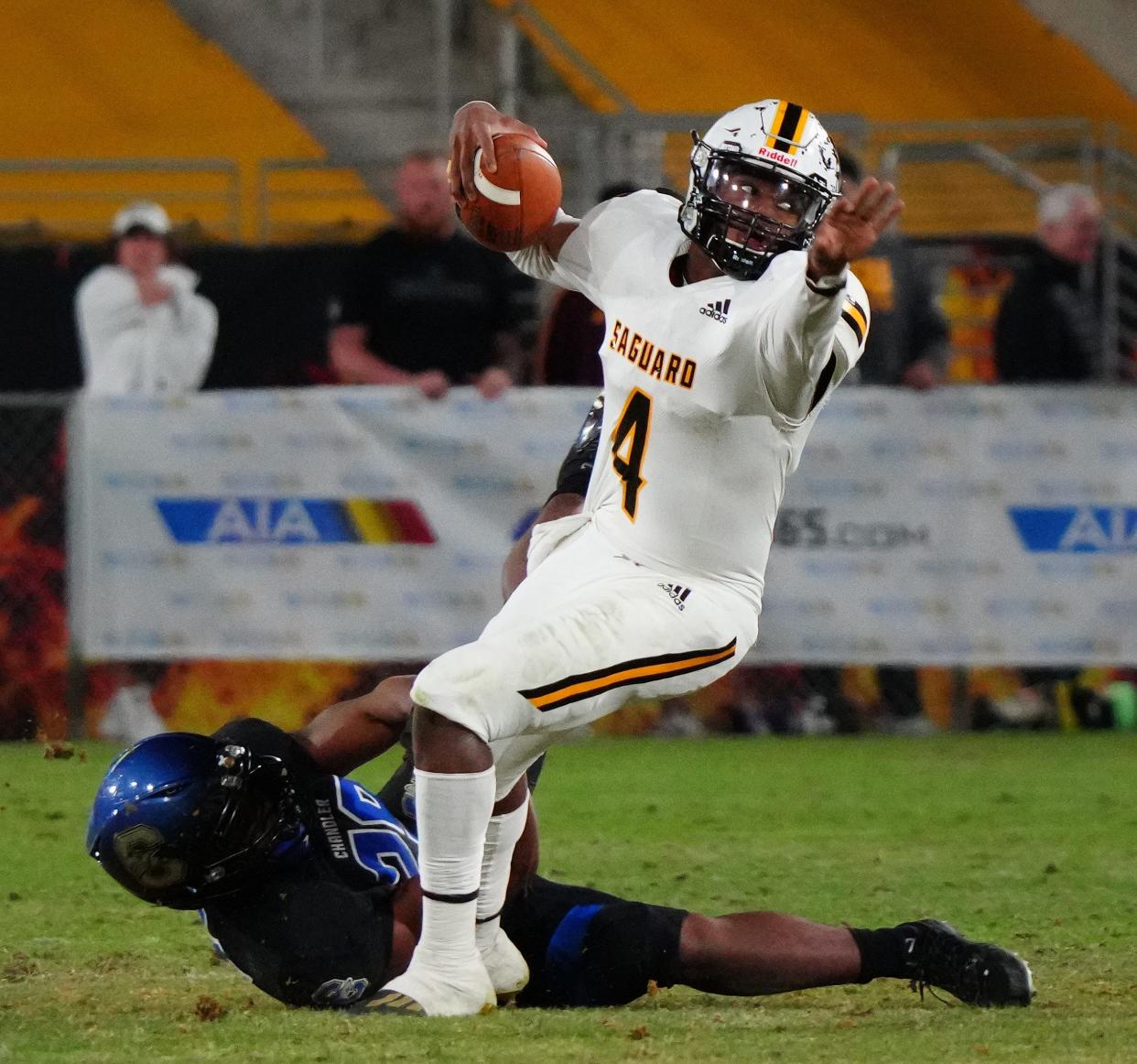 Dec 11, 2021; Phoenix, AZ, United States; Chandler's Dason Brooks (29) grabs ahold of Saguaro's Devon Dampier (4) as he scrambles during the second half of the Open Division State Championship Game at Arizona State Sun Devil Stadium. Mandatory Credit: Patrick Breen-Arizona Republic