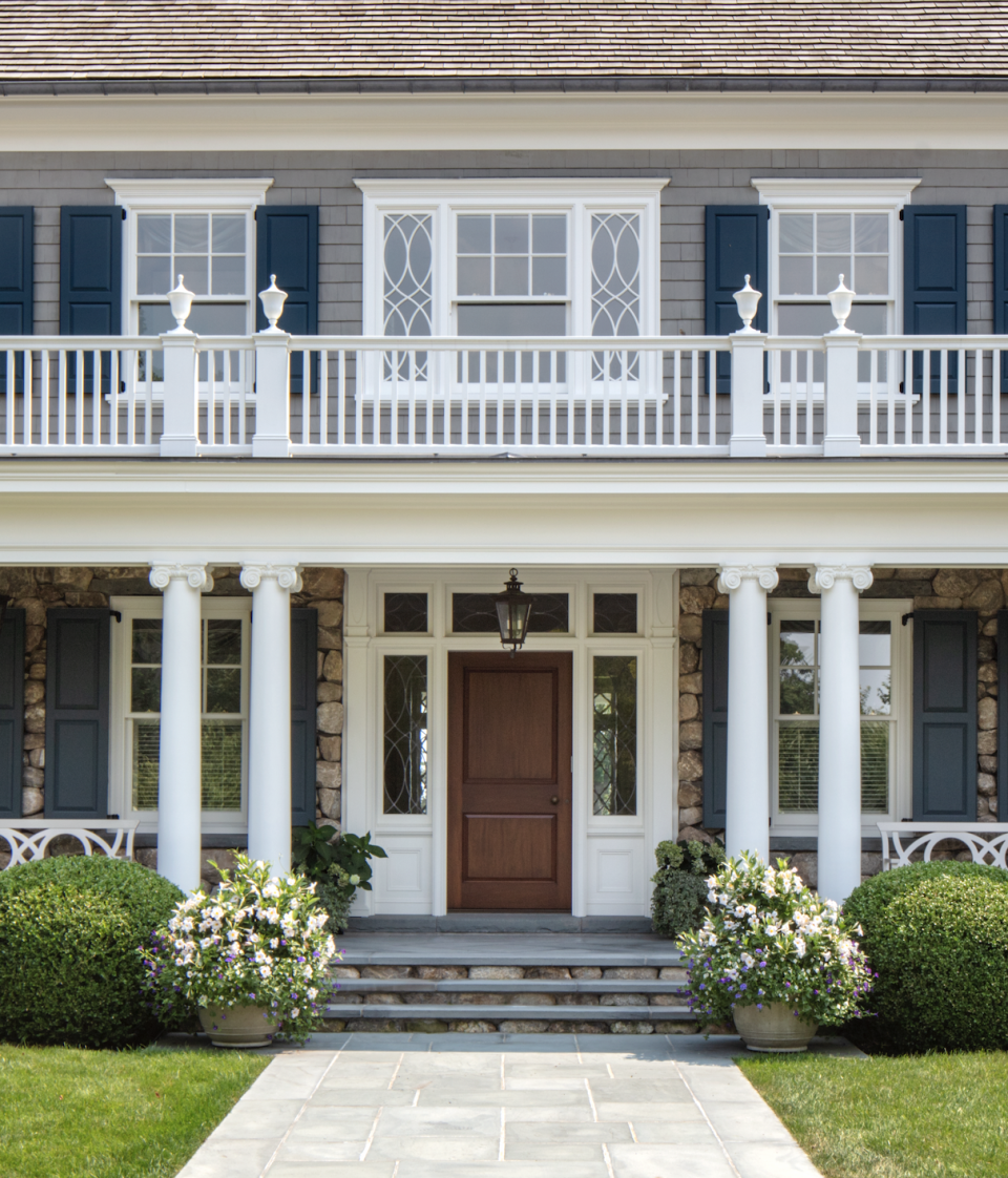 a house with white pillars and a front porch